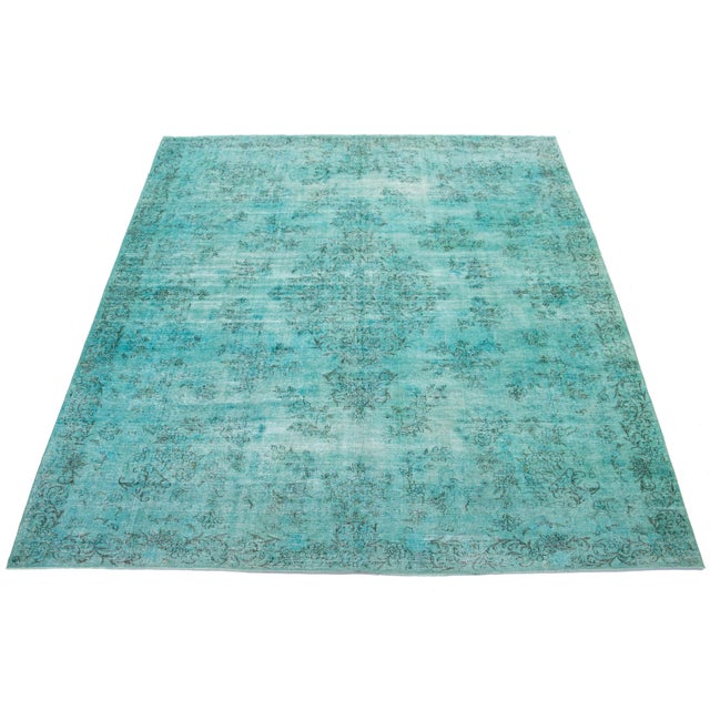 This is a Turquoise antique hand-knotted Persian wool rug with a medallion floral design and gray accents. This rug...