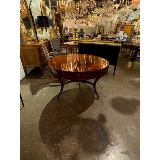 The Early 19th Century German Biedermeier Mahogany Center Table is classic piece with antique roots. This elegant table...