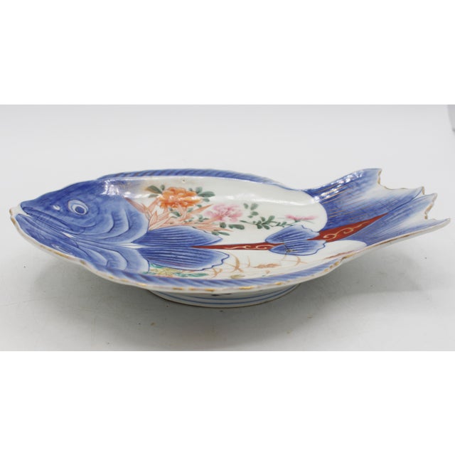 Circa 1880 Imari fish plate, Japan. The double fish (filleted fish) has lovely body reserves of chrysanthemums. Hairline...