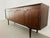 Make a statement with this exceptional Scandinavian Modern credenza, a showpiece with rich, dramatic rosewood grain and a...