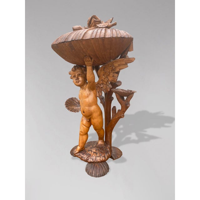 A 19th century impressive large scale Italian Baroque style putti statue, depicts a winged cherub, with branch, different...