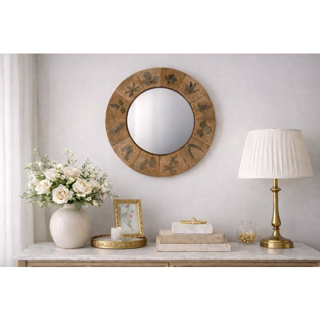 Round terracotta mirror composed of individually molded ceramic tiles impressed with natural botanical plant motifs,...