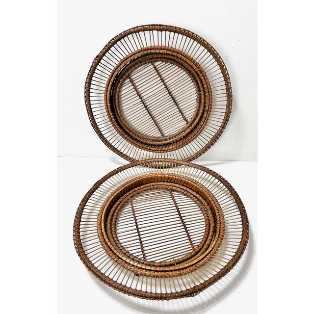 A striking set of six oversized vintage rattan plate holders, designed with airy radial spokes and beautifully hand-...