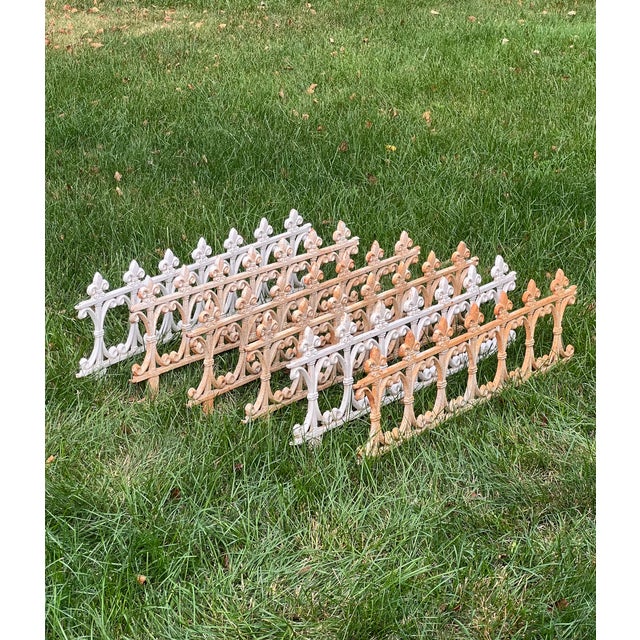 Set of six interlocking cast iron garden edging fences with fleur-de-lis and white paint patina, early to mid-20th...