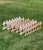 Set of six interlocking cast iron garden edging fences with fleur-de-lis and white paint patina, early to mid-20th...