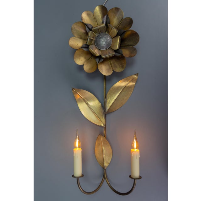 Mid-Century Modern brass and metal flower-shaped twin arm sconce, France, 1950s. This beautiful Mid-Century Modern wall...