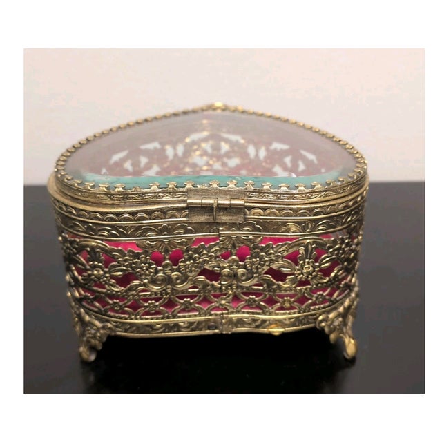 Charming vintage heart-shaped jewelry casket crafted in an ornate gilt ormolu-style metal frame with intricate pierced...