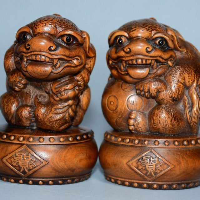 This charming pair of carved boxwood guardian lions brings a warm, organic presence to any interior. Each lion is finely...