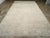 A wool pile of symmetric knots on a cotton foundation. With a significantly reduced palette, the light brown field hosts...