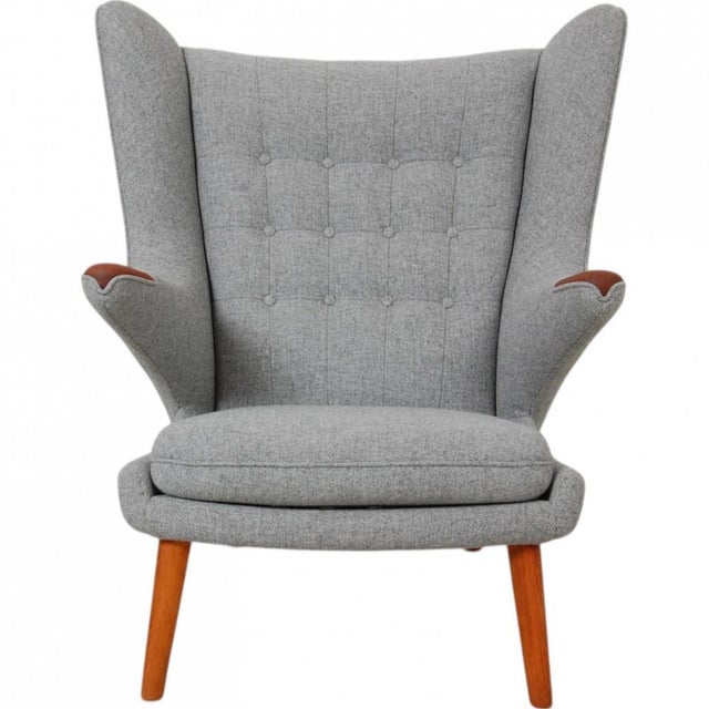 Hans Wegner Papa Bear chair upholstered in grey Hallingdal 65 - 0130 fabric and with legs and nails of teak. The chair is...