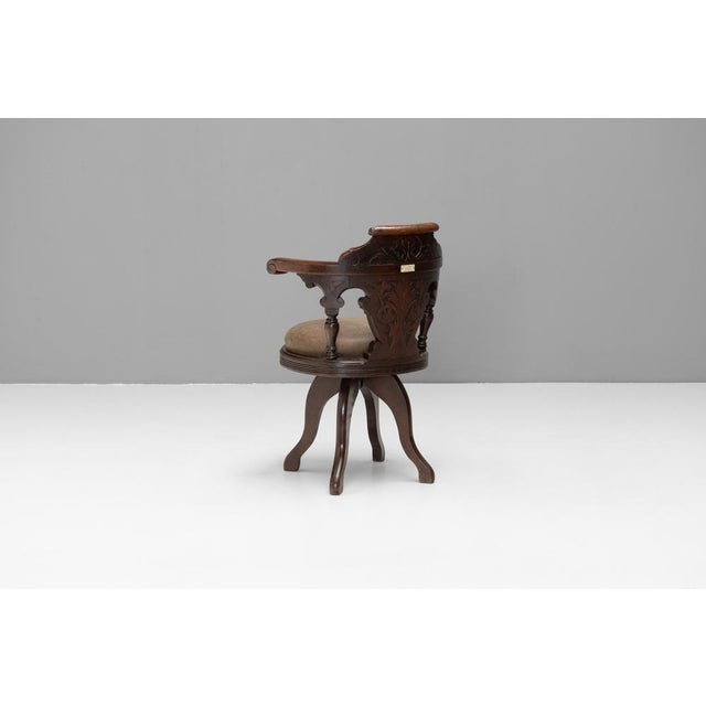 Solid mahogany ships swivel chair by Thomas W Ward Ltd, Sheffield. Hand carved details and newly upholstered seat pad....