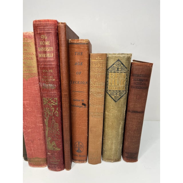 Set of 11 vintage and antique books in shades of reds and browns. Varying subject matters and sizes. Condition varies and...