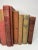 Set of 11 vintage and antique books in shades of reds and browns. Varying subject matters and sizes. Condition varies and...