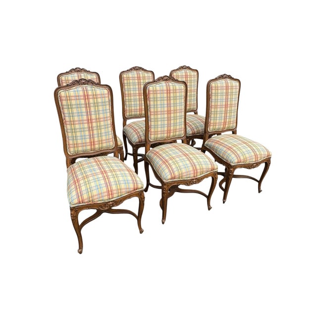 Set of 6 armless wood and upholstered armless French dining chairs. Carved floral details and cabriole legs. Cross x...