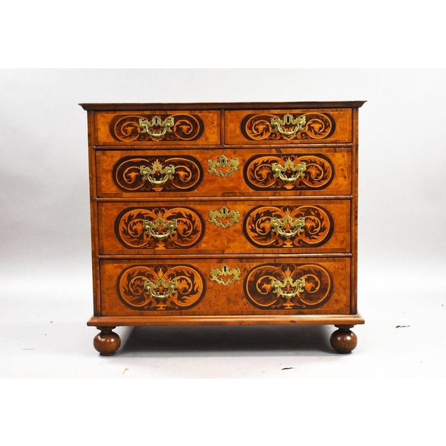 A highly decorative antique William and Mary marquetry chest of compact proportions, beautifully crafted and richly...