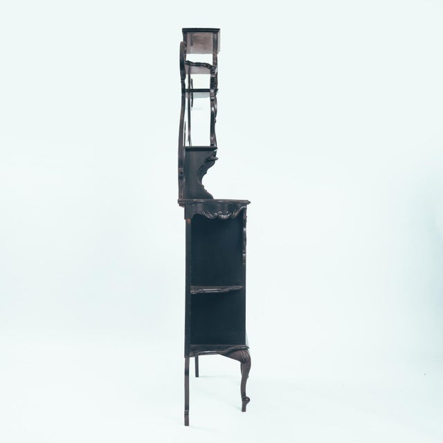 Beautiful ebonized and slender Arts and Crafts parlour glass display cabinet by Maddox ltd &co from Screwsbury. This...