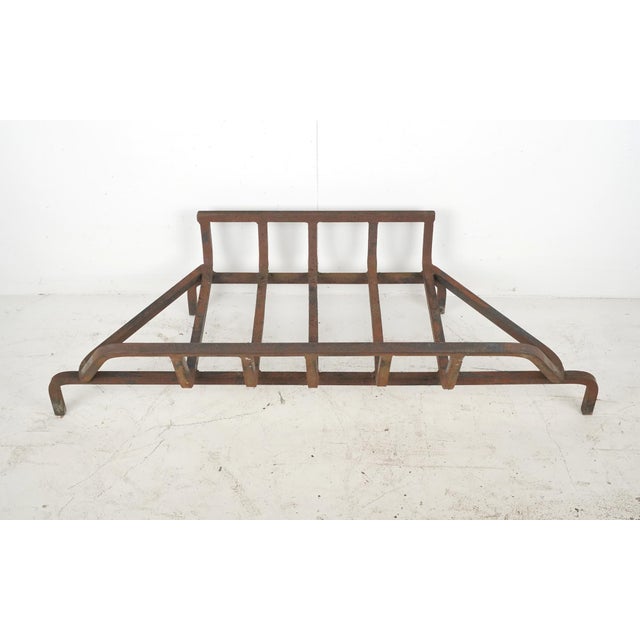 Reclaimed large cast iron fireplace log holder grate. This heavy duty industrial piece is designed to hold logs in place...