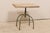 An industrial style side table with wood top over iron base. This vintage occasional table features a rectangular-shaped...