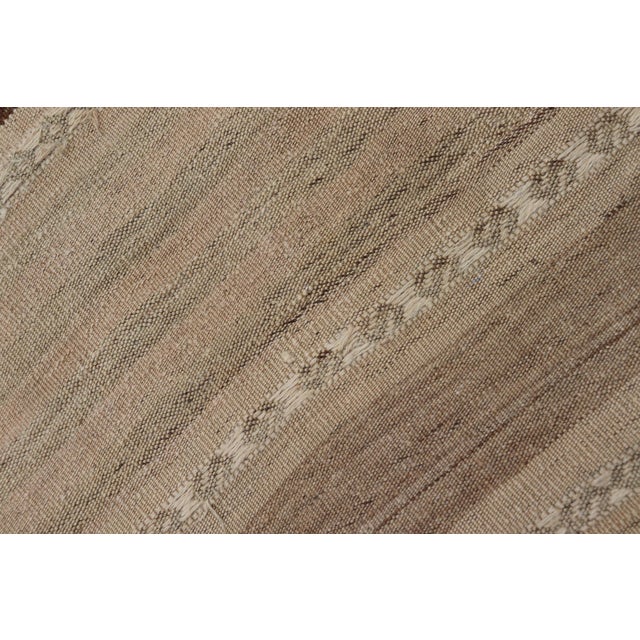 Measures: 2'5" x 10'10" This vintage Turkish Kilim runner from the 1950s features a classic striped design, showcasing the...