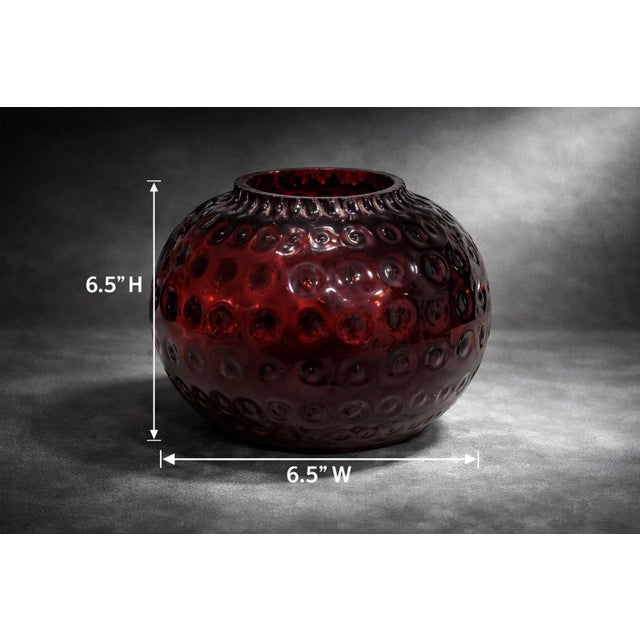 Striking cranberry red hobnail art glass orb vase featuring a richly colored body and sculptural raised pattern...