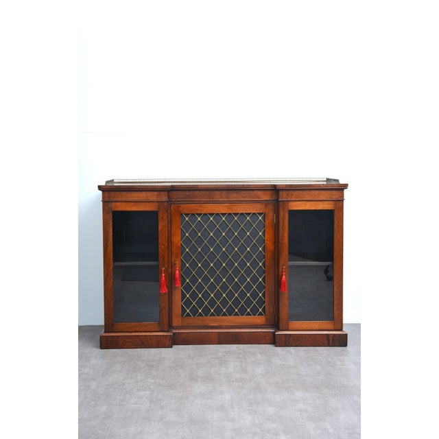 A fine and elegant regency / george iv period rosewood inverted breakfront cabinet bookcase. This versatile piece,...