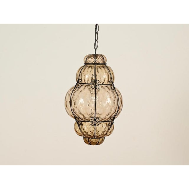Stunning large lantern chandelier in murano mouth-blown amber glass and wrought iron. This fantastic piece was produced by...