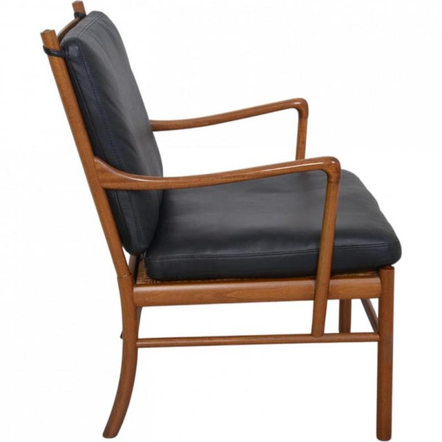 Ole Wanscher Colonial chair with a frame of mahogany and cushions of black leather. The chair is from around the 1990s and...