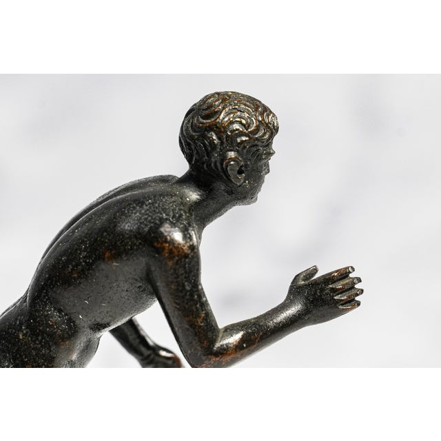 This handsome circa 1890 Grand Tour bronze is a miniature reduction of the celebrated Herculaneum Runner, one of the most...