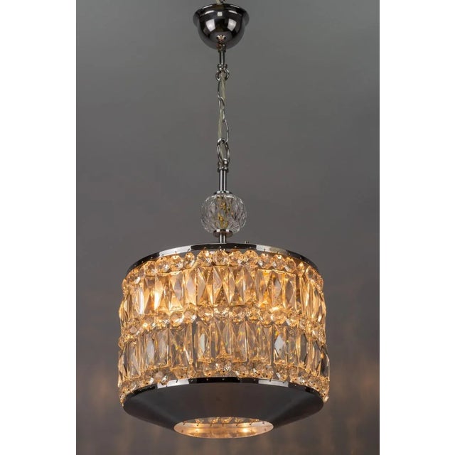 - Impressive Mid-Century Modern crystal glass and chrome pendant light with three interior lights. - Light reflects...