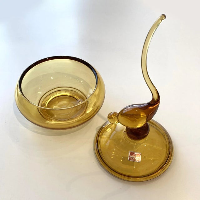 This Vintage, Viking Tailed, Art Glass, Bird Candy Jar in amber color is from the 1960s. It features a long-tailed bird...