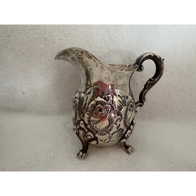 Ornately decorated with roses and scrolls, this Sterling Silver Tray with Sugar Bowl and Milk Pitcher is stylish and...