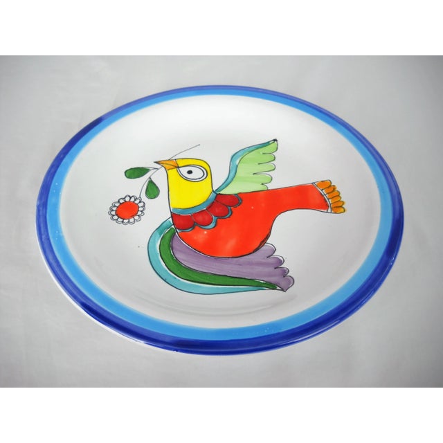 Vibrant hand-painted Italian Desimone plate featuring a dove with olive branch. Signed on base, "Desimone, Italy for Vietri".
