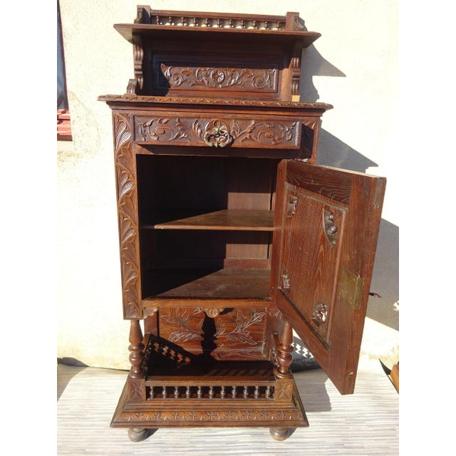 Small storage cabinet, finely hand-carved French. Originating from Brittany, depicting a scene of daily life in bas-...