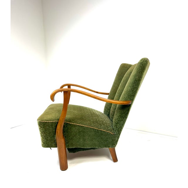 1940’s Swedish Lounge Chair. Elegantly sculpted Birch wood frame. Original upholstery.