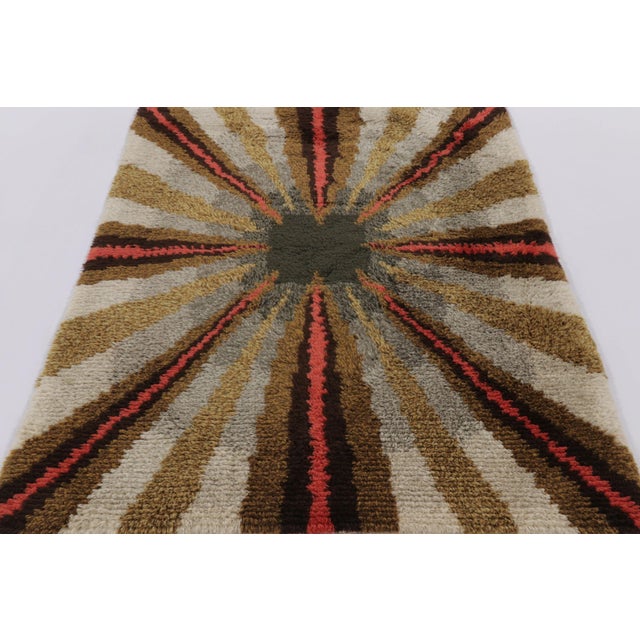 Hand-knotted in lush, high-pile wool in Sweden circa 1960-1970, this 5x6 vintage Swedish Rya rug is a bold new addition to...