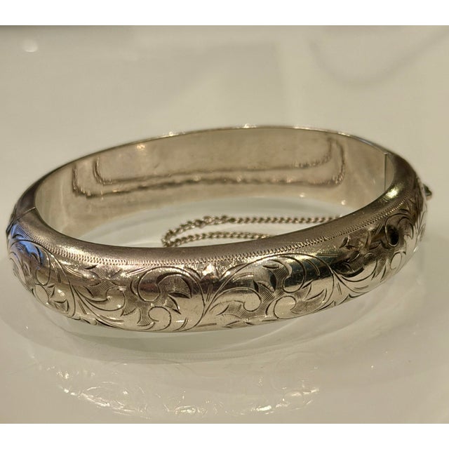 Vintage Art Nouveau style hinged bangle bracelet with etching. This lovely 950 sterling bracelet has an elegant leaf and...