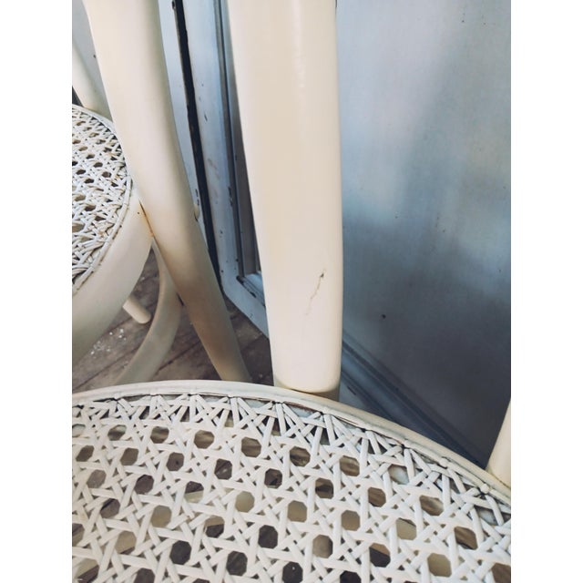 Set of four white cane bistro chairs. Timeless elegance of bentwood. Some minor paint loss. The caning is traditional and...