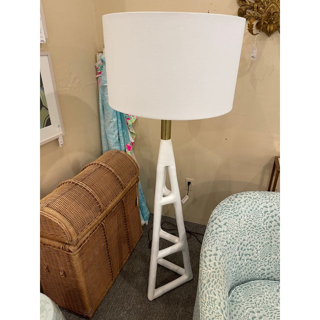 Tanner floor lamp is white hot with a hand-textured steel frame base and natural brass hardware accents. The oversized...