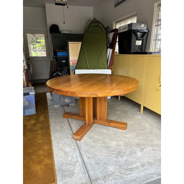 Vintage danish round dining table crafted from solid wood with a warm honey-toned finish. This piece features a thick,...
