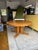 Vintage danish round dining table crafted from solid wood with a warm honey-toned finish. This piece features a thick,...