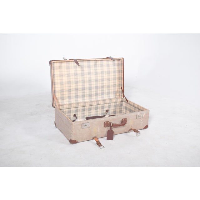 Travelling bag with leather. Rectangular in shape, with a rigid structure and generous proportions, it has a discreetly...