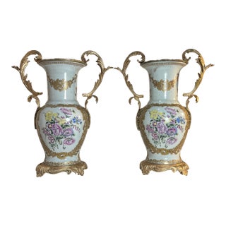 Vintage Ormolu Rococo Ceramic Urns With Floral Motif- A Pair For Sale