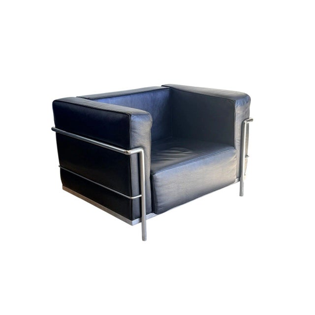 Iconic Le Corbusier LC2 style lounge chair in black leather with polished chrome frame. A timeless mid-century modern...