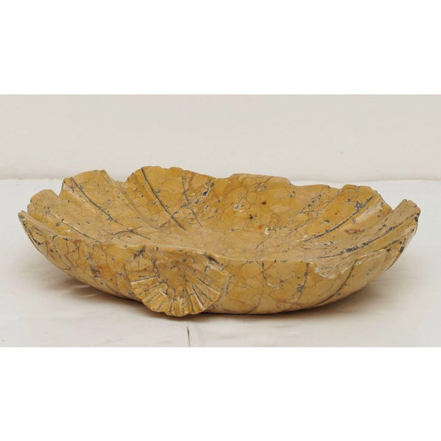 A fine Italian font tray or bowl centerpiece of Siena marble, featuring a carved shell design with shell relief on its...
