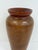 Hand turned wooden vase with a tapered form and wide flared rim. Made from solid wood with visible grain and a warm brown...