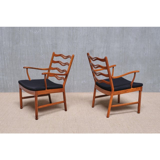 This rare pair of armchairs was designed by Ole Wanscher and produced by Fritz Hansen in Denmark in the mid-1940s. Both...