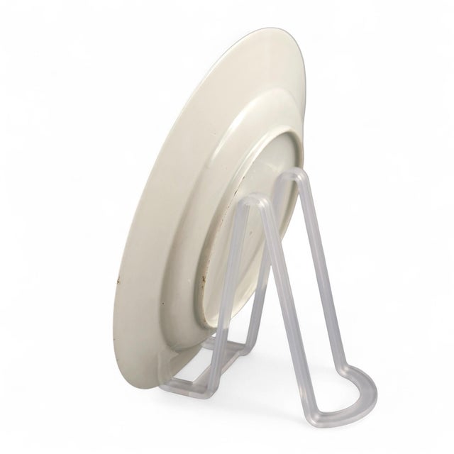 A refined Japanese porcelain dish from the first great Arita enamel phase. Painted in the aka-e palette of iron-red, green...