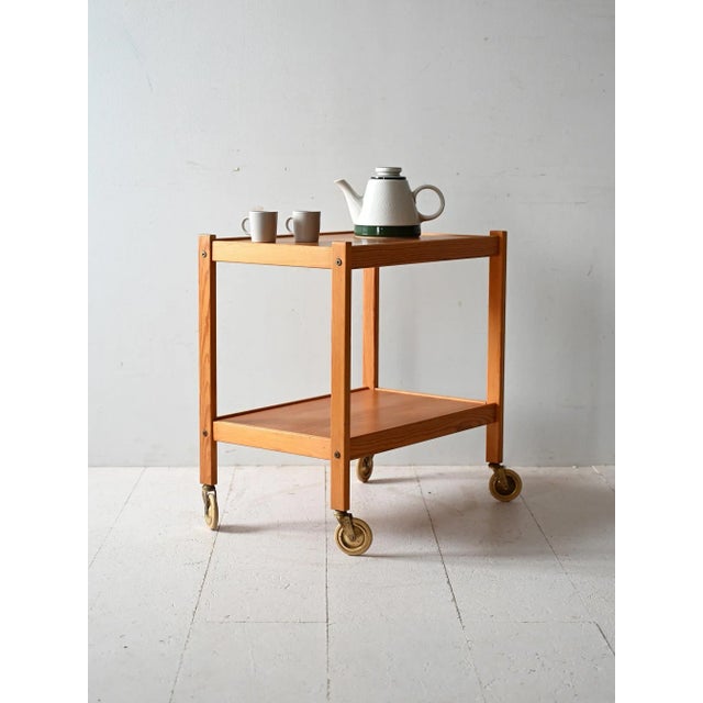 Simple pine wood structure with a removable tray and original metal casters. Scandinavian pine cart from the 1960s, with...
