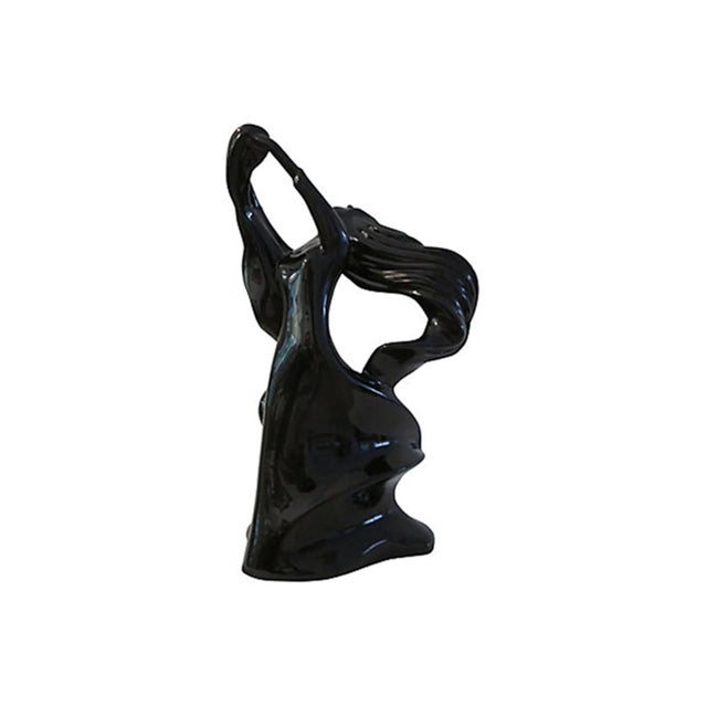 Large stunning gloss black ceramic figure of a flowing-haired woman in mid-dance. Excellent vintage condition.