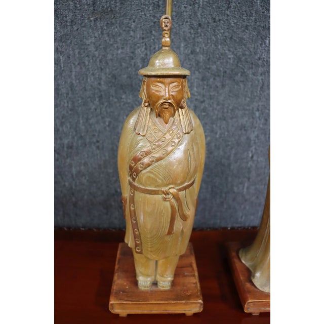 A pair of Chinese carved lamps on pine with mahogany base.